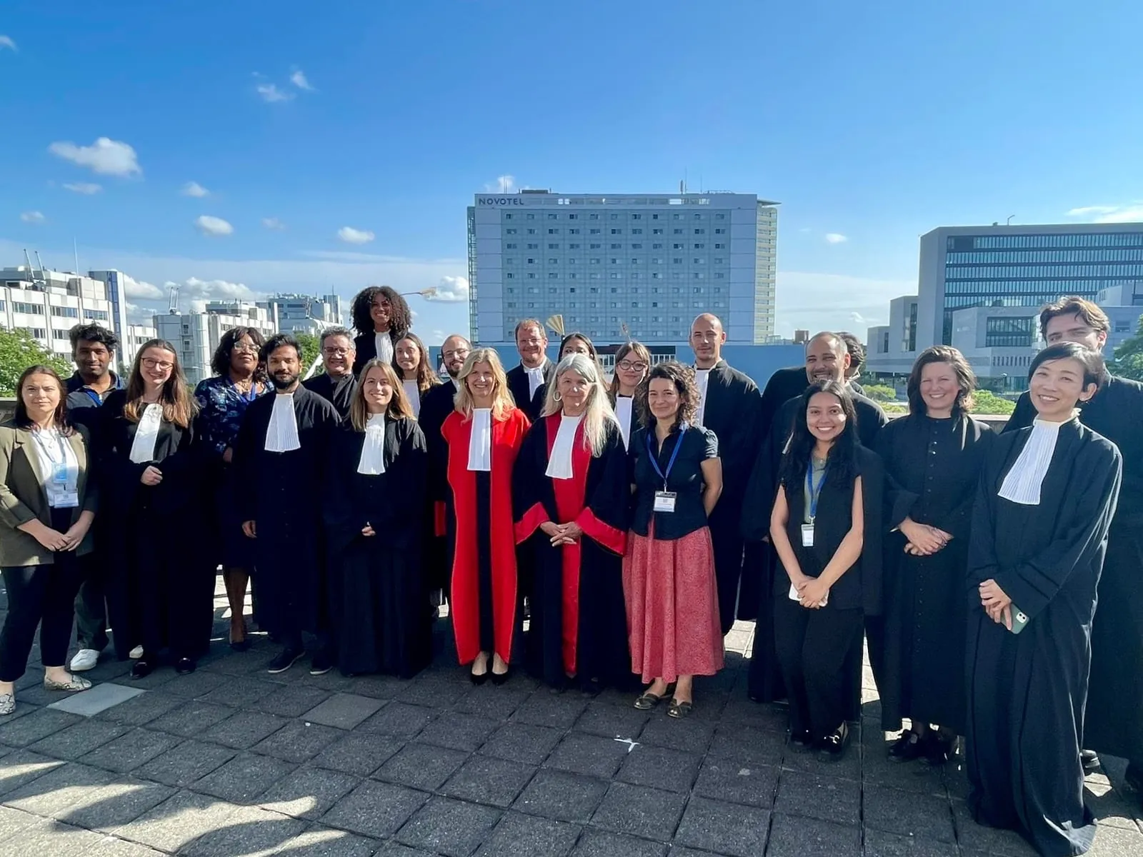 Group photograph of participants and judges on a rooftop terrace at the 2023 Mock Trial and Training organised by the Association of Defence Counsel at the IRMCT, The Hague